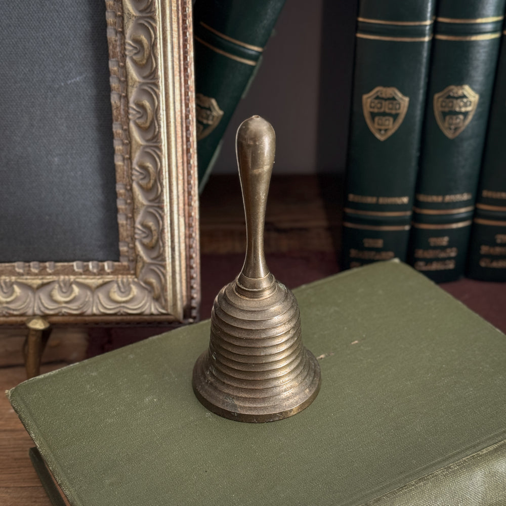 Vintage striped brass bell.