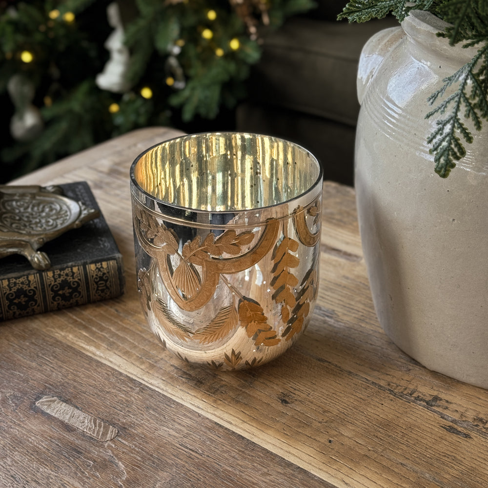 Etched gold mercury glass votive.