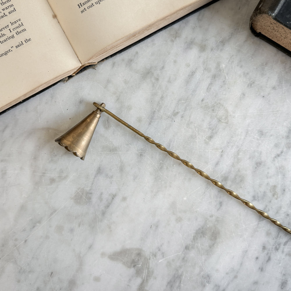 Vintage brass candle snuffer.