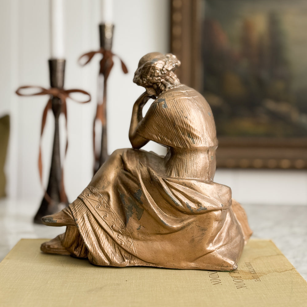 Vintage gold woman of music statue.