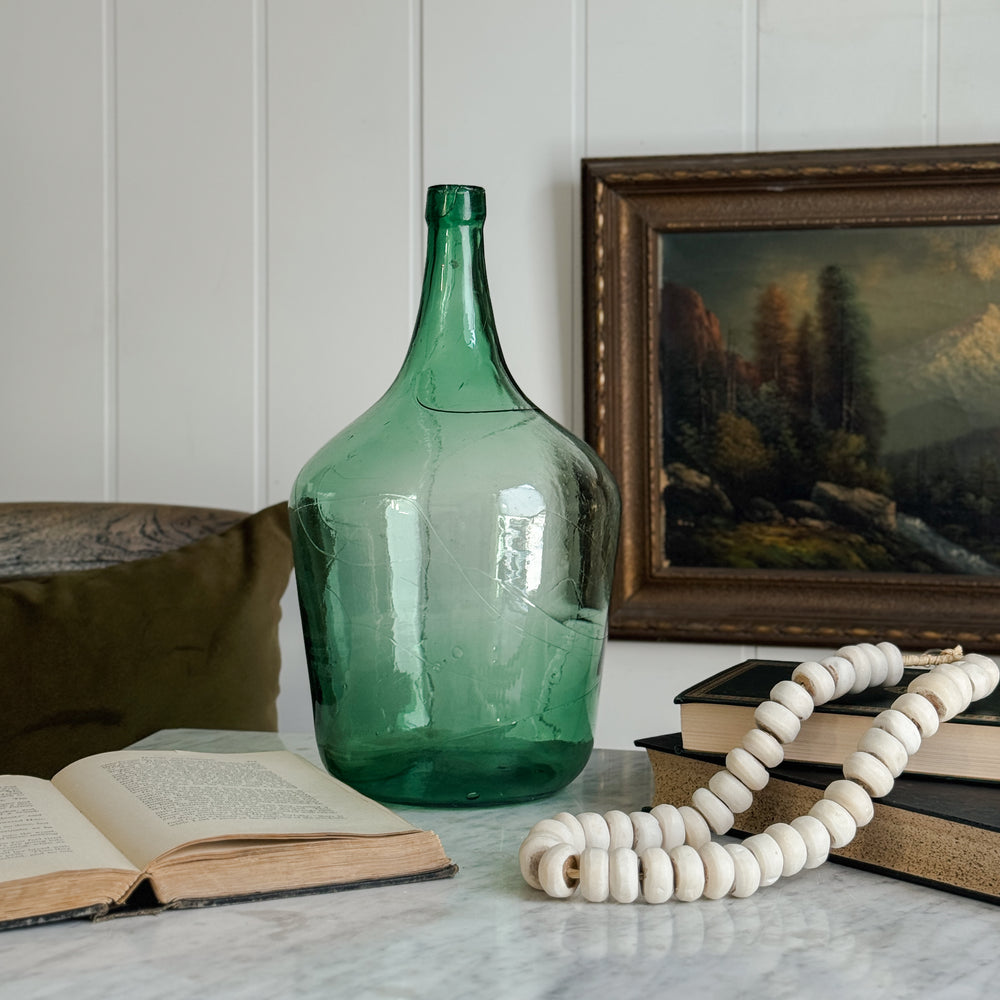 Vintage green European demijohn.