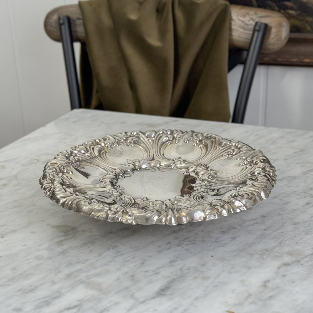 Vintage ornate round footed silverplate tray.