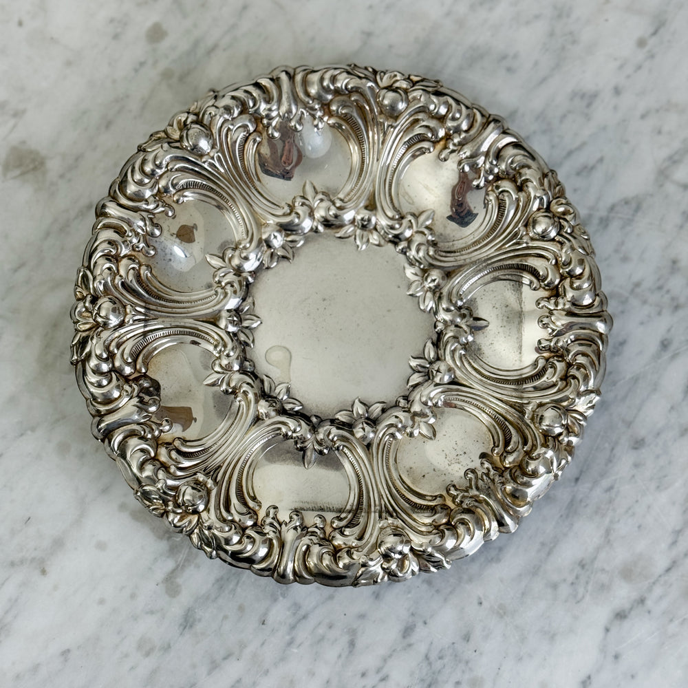 Vintage ornate round footed silverplate tray.