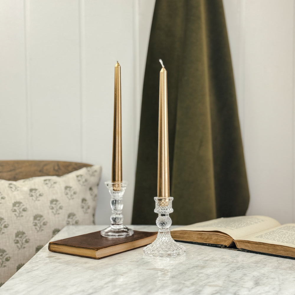 Metallic gold taper candle.