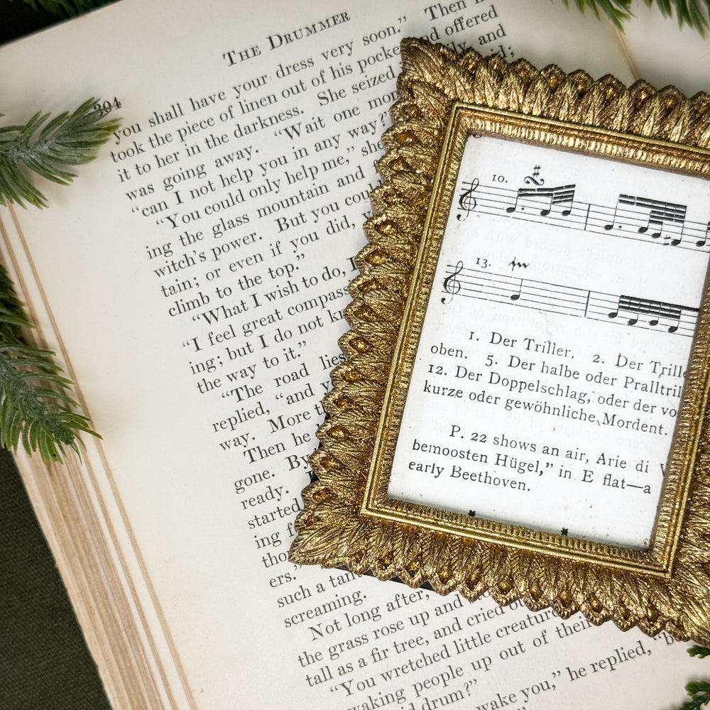 Antiqued Gold Feathered Frame.