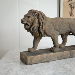 Aged brown Concrete Lion Statue.