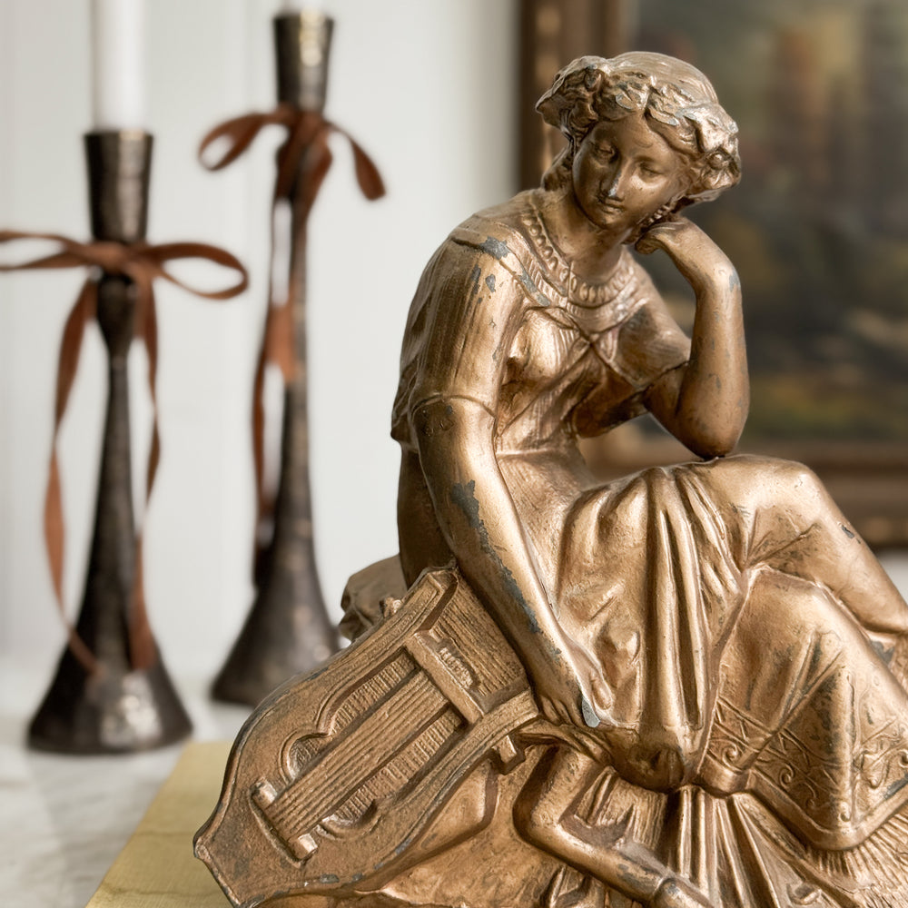 Vintage gold woman of music statue.