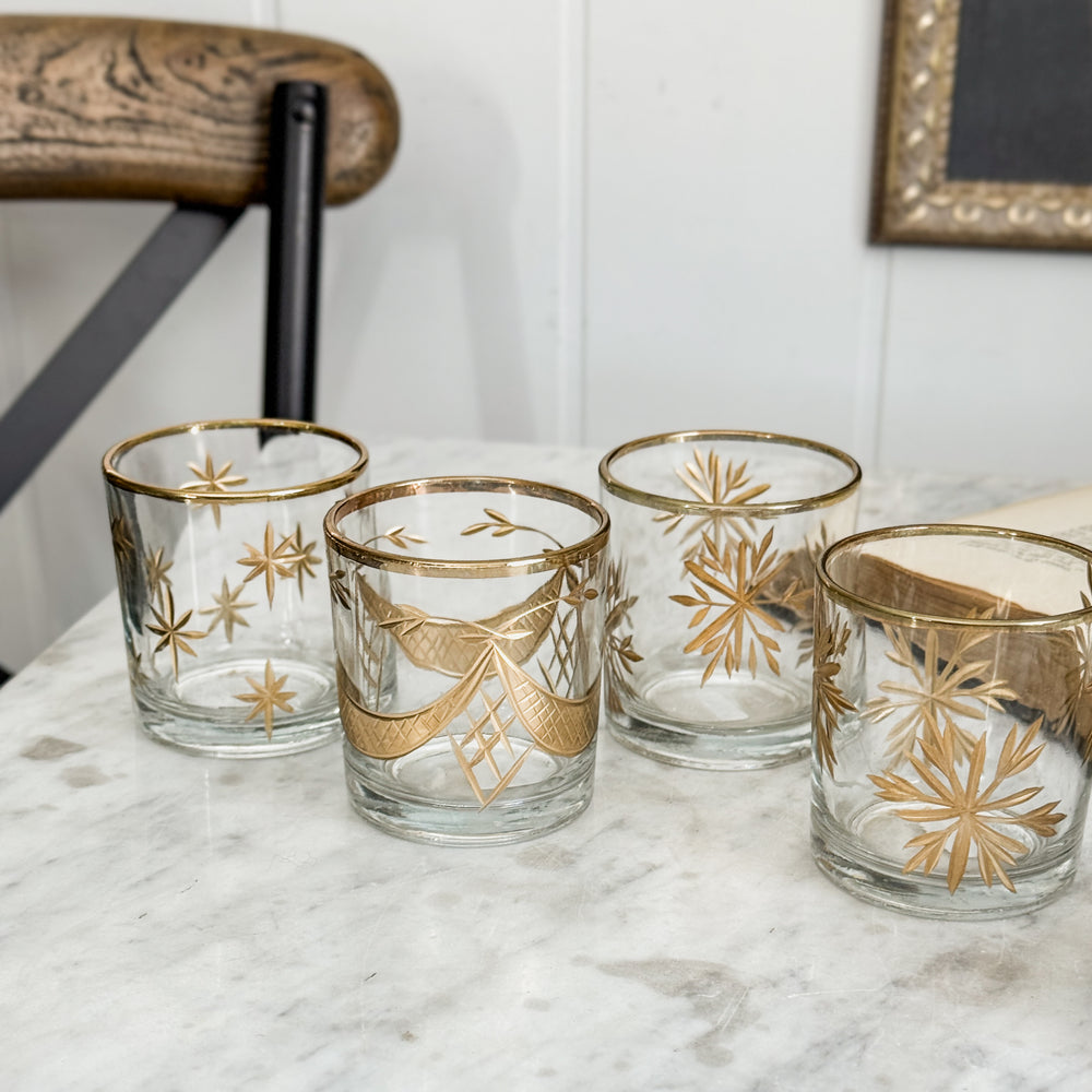 Etched gold glass votive holder.