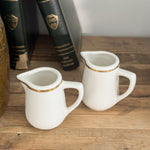 Vintage buffalo gold rim creamer.