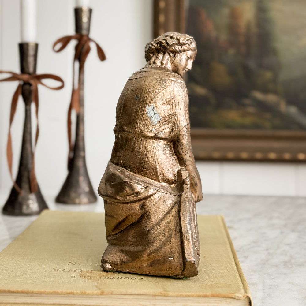 Vintage gold woman of music statue.