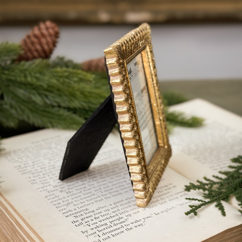 Antiqued Gold Feathered Frame.