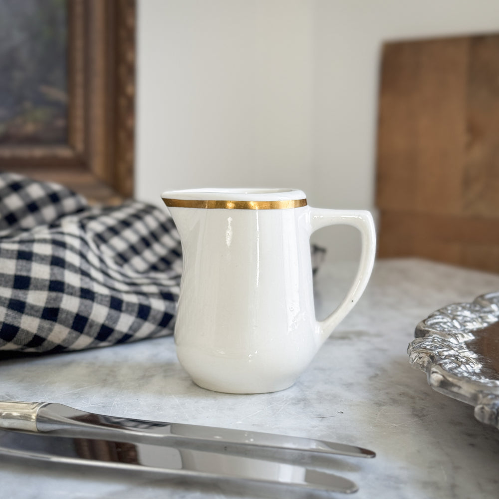 Vintage buffalo gold rim creamer