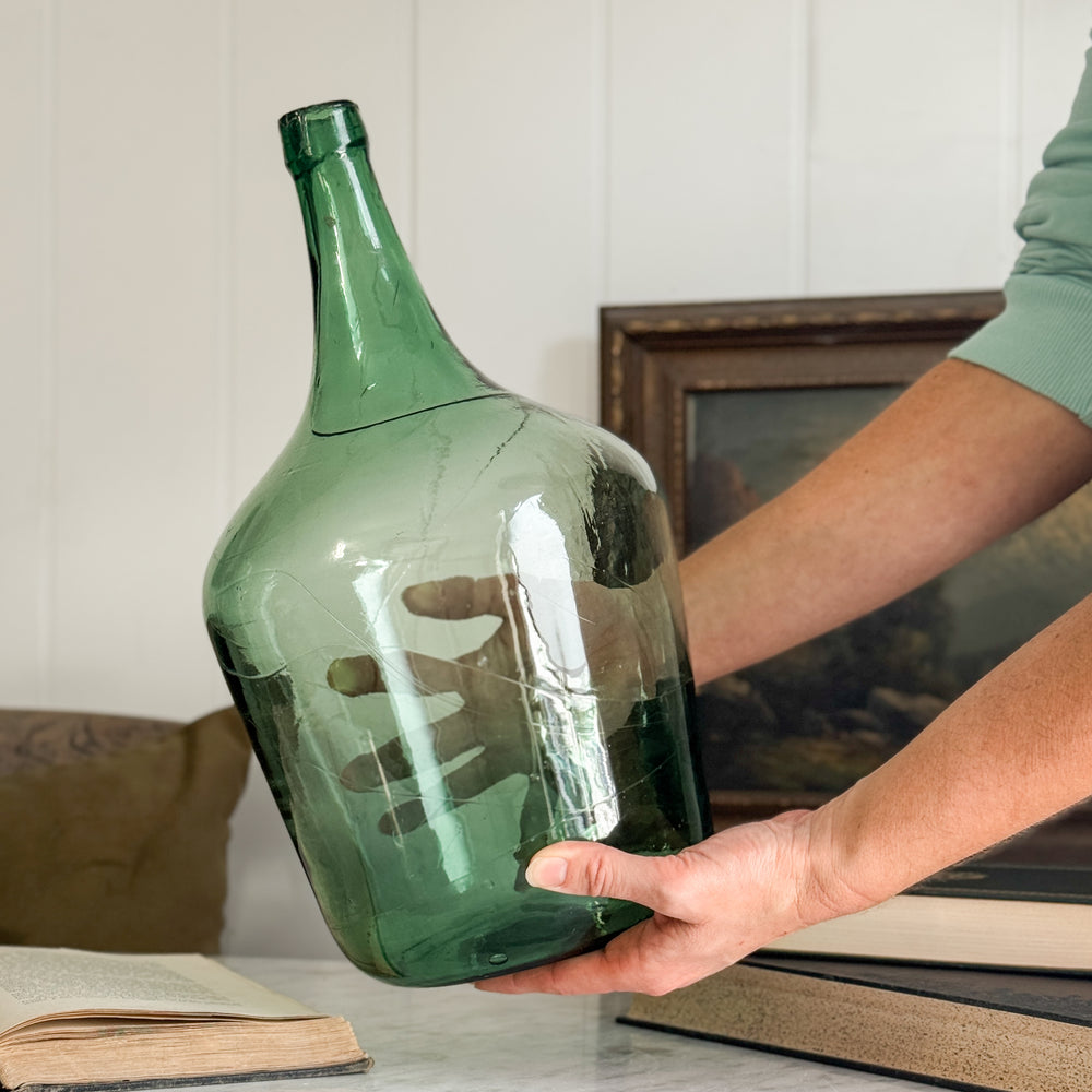 Vintage green European demijohn.