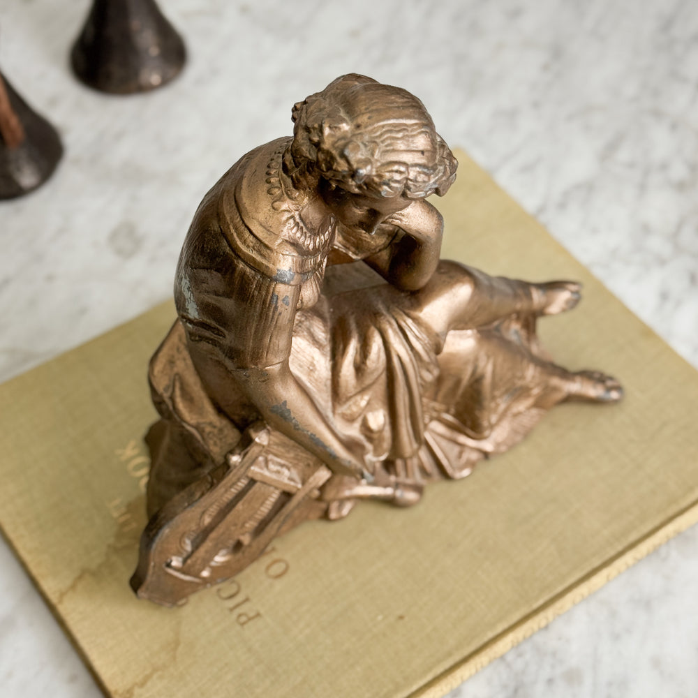 Vintage gold woman of music statue.