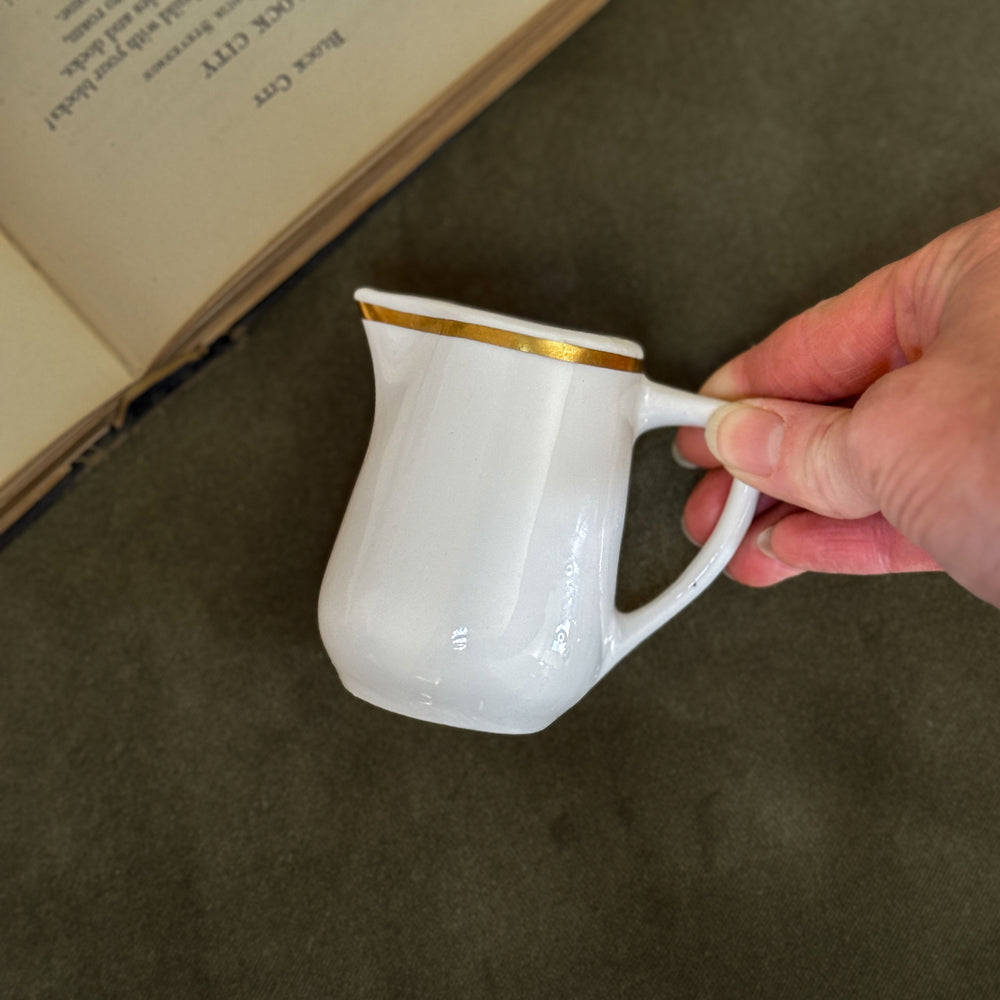 Vintage buffalo gold rim creamer