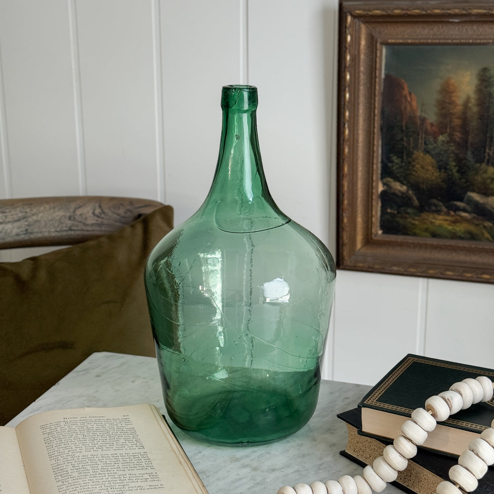 Vintage green European demijohn.