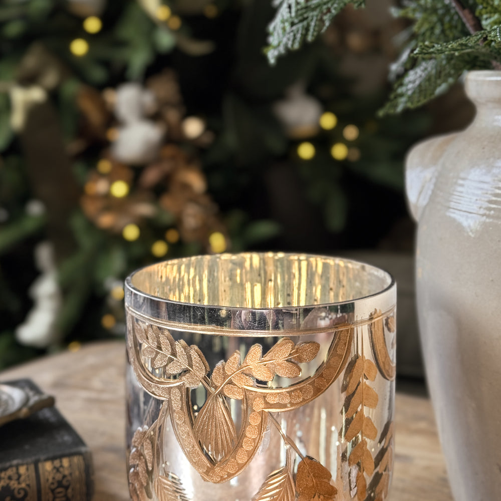 Etched gold mercury glass votive.