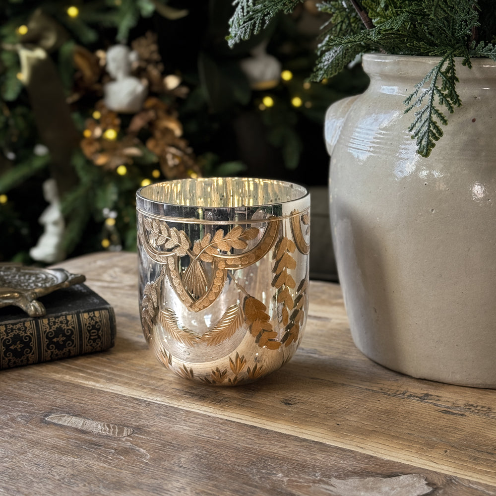 Etched gold mercury glass votive.